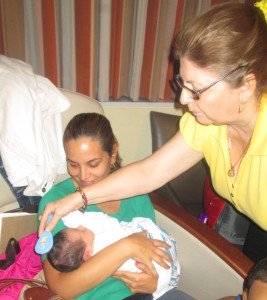 Titi Luisa, the Gold Standard for Baby Whisperers brushing Cristian's hair.